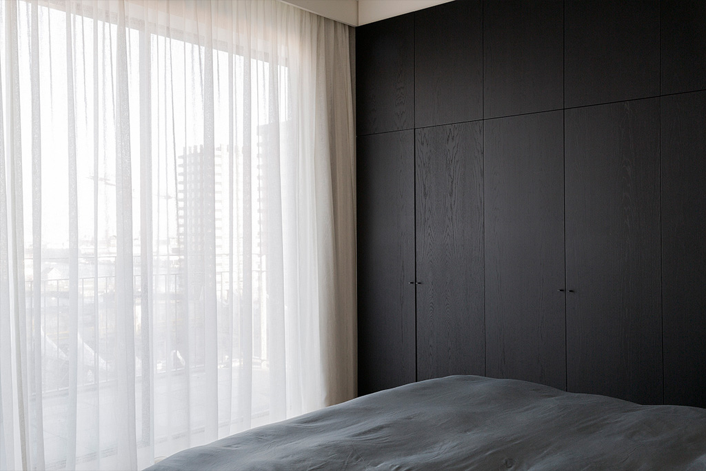 Slaapkamer met zwarthouten grote meubel